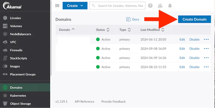 Linode dashboard displaying the 'Domain' section with a running domains. A red arrow points to the 'Create Domain' button on the right side of the screen.