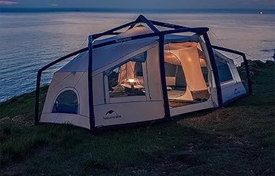 Naturehike inflatable tent at dusk, set up near a scenic water view, providing a cozy and windproof shelter.