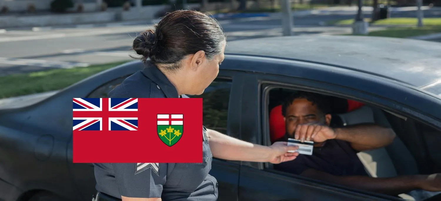 Man showing his driver's license to a police officer during a traffic stop.