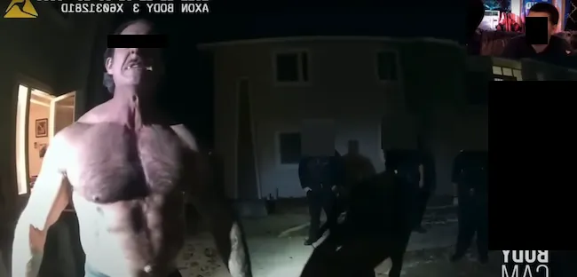 A chaotic scene showing a shirtless Florida man under the influence of substances, aggressively yelling towards the camera while being surrounded by several police officers, illustrating the wild and unpredictable nature often associated with 'Florida Man' incidents.