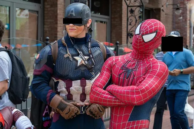 Two individuals fully dressed in cosplay costumes of Spider-Man and Captain America, actively participating in a live-action role-play (LARP), bringing comic book characters to life in an outdoor setting.