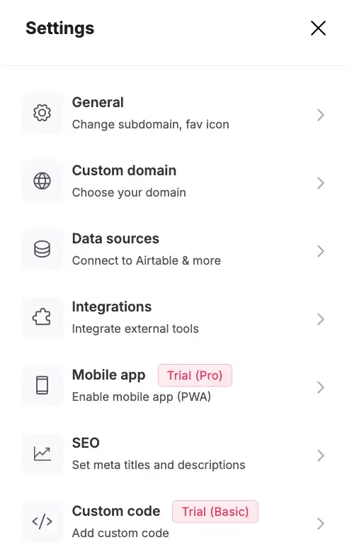 Softr builder showing setting options (general, custom domain, data sources, integrations, mobile app, SEO, custom code) screenshot #1